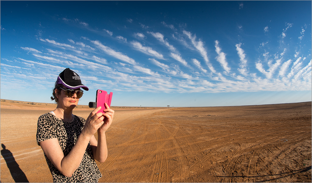 Iphone in hand "Mim of the Outback" pans the vision splendid 50 Ks north of Birdsville, Far West Queensland